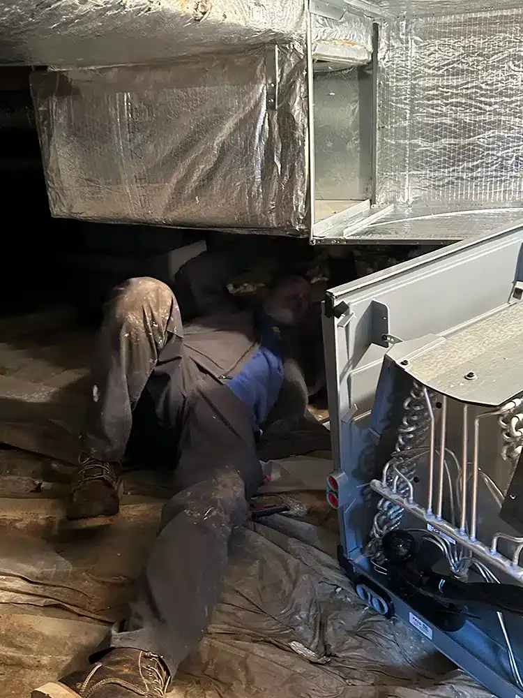 Tech repairing HVAC system in Lexington, KY.
