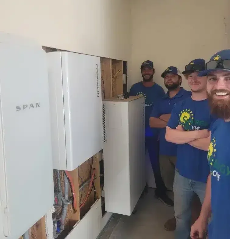 Synergy Home team in front of electric panels in Lexington, KY.