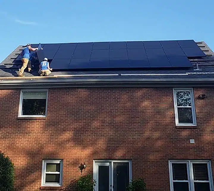Techs installing solar panels on roof in Lexington, KY.
