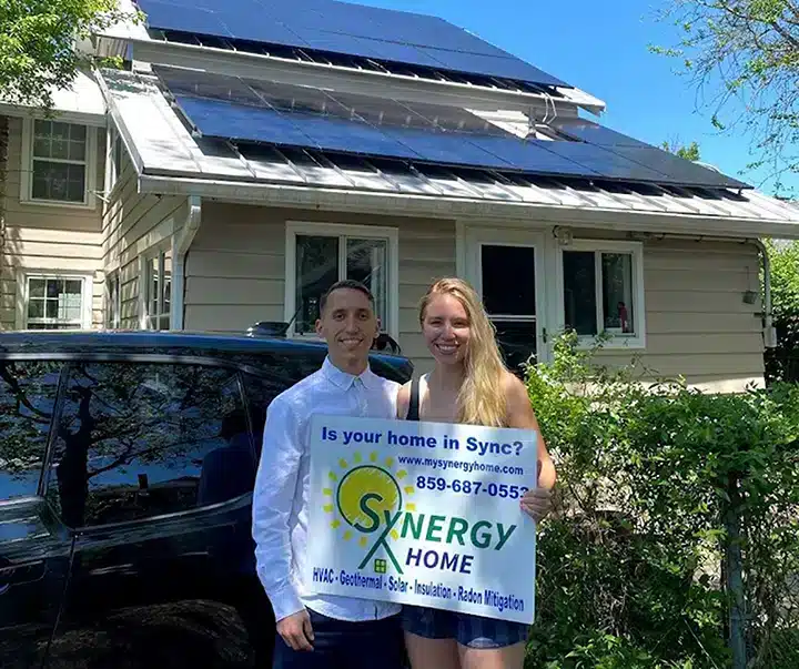 Synergy solar customers smiling in front of new solar panels in Lexington, KY.