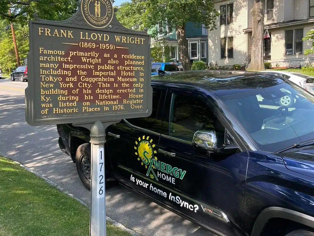 Synergy Home truck behind historical sign in Lexington, KY.